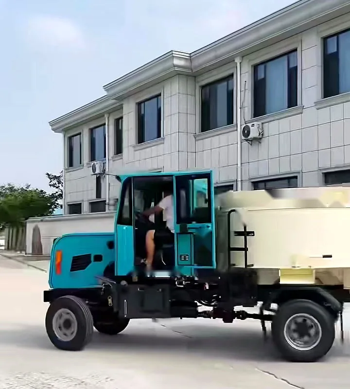 A self-loading concrete mixer being driven along a plant road past an office building