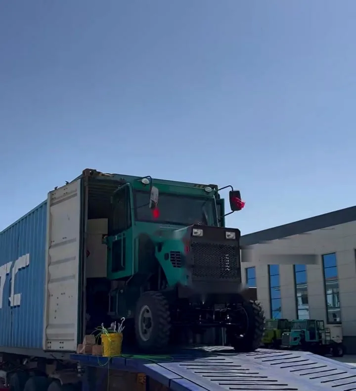 Self-loading concrete mixer driven fully into a shipping container on a trailer, nose facing out, doors still open